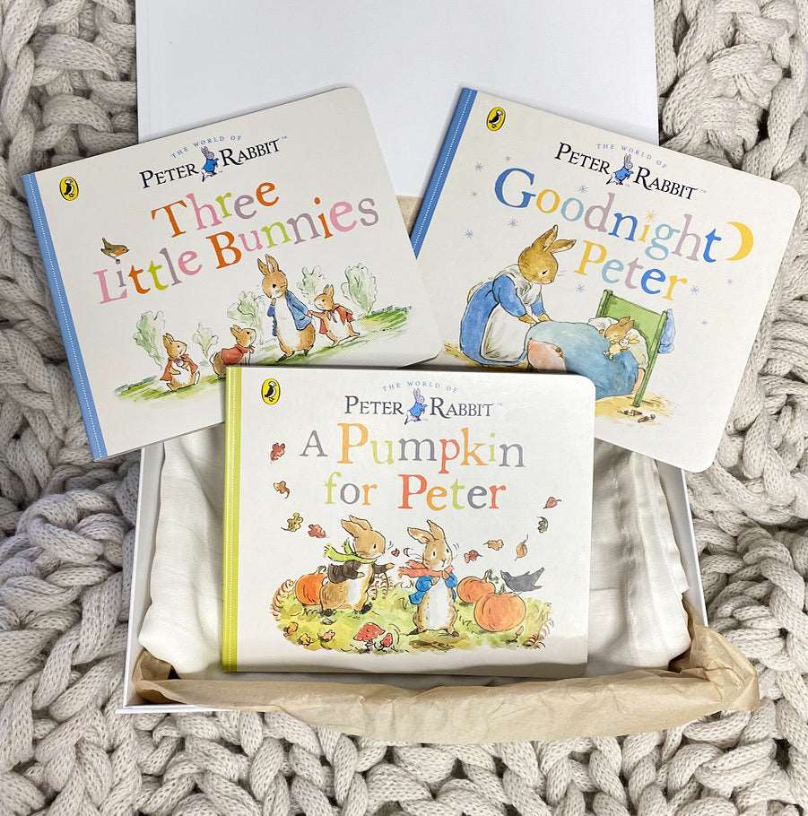 A collection of Beatrix Potter Peter Rabbit books neatly arranged in a decorative box, showcasing their colorful covers and charming illustrations.