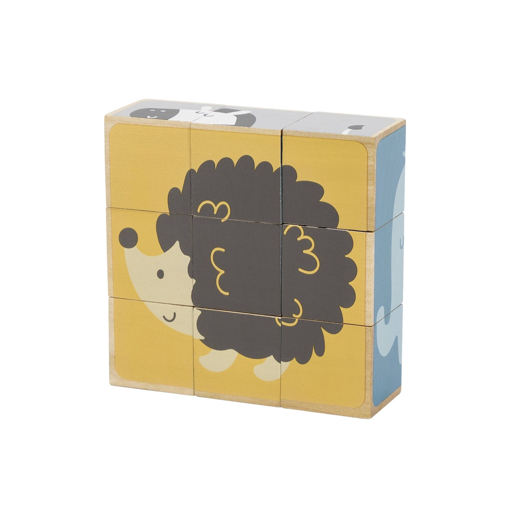 A 6-sided wooden toy puzzle made by PolarB, featuring nine cube blocks assembled in a wooden tray. The blocks display a cheerful cartoon hedgehog on a yellow background, forming one of the six potential puzzle images. The wooden tray sits behind the assembled cubes, with other puzzle designs visible on the sides.