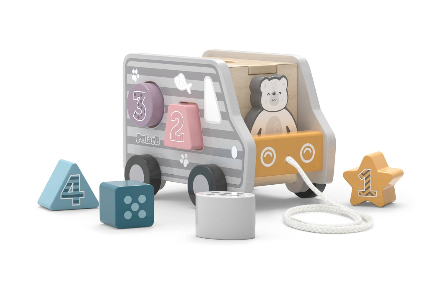 A wooden toy shape sorter made by PolarB designed as a pull-along truck. The truck features a cute bear illustration on the front and gray stripes along the sides. Various numbered blocks, including a star, triangle, and cylinder, are placed around the truck, each with a corresponding shape slot on the side for sorting. A string is attached to the front for pulling the toy.