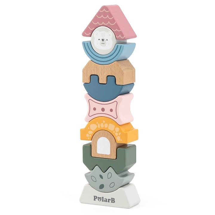 A wooden block tower toy puzzle made by PolarB, featuring uniquely shaped and brightly colored pieces stacked vertically. The blocks include various geometric and abstract shapes, such as arches, waves, and a triangle at the top with a smiling bear face. The base of the tower is labeled ‘PolarB.