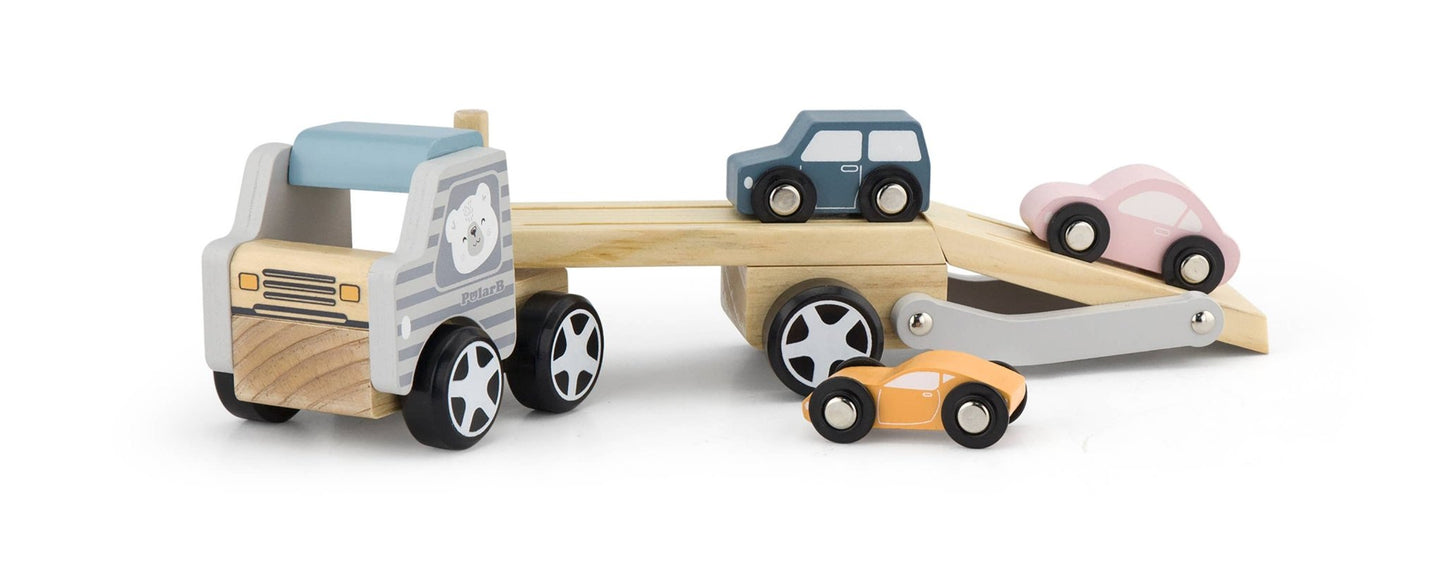 A wooden toy car transporter made by PolarB, featuring a light brown carrier truck with a gray-striped cab, an illustrated bear on the side, and a movable two-level ramp. The set includes three small wooden toy cars in pastel yellow, pink, and blue, designed to be loaded onto the carrier.