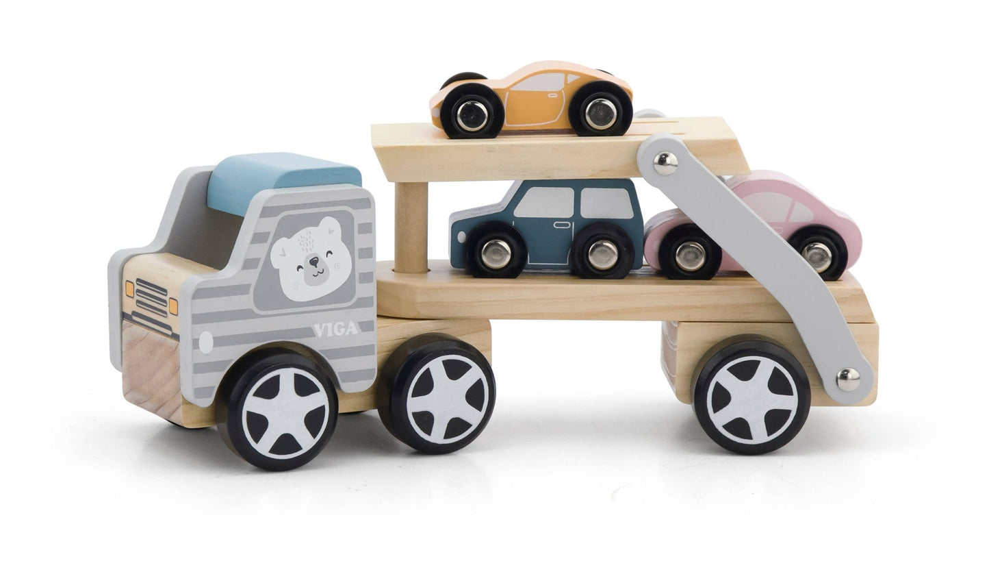 A wooden toy car transporter made by PolarB, featuring a light brown carrier truck with a gray-striped cab, an illustrated bear on the side, and a movable two-level ramp. The set includes three small wooden toy cars in pastel yellow, pink, and blue, designed to be loaded onto the carrier.