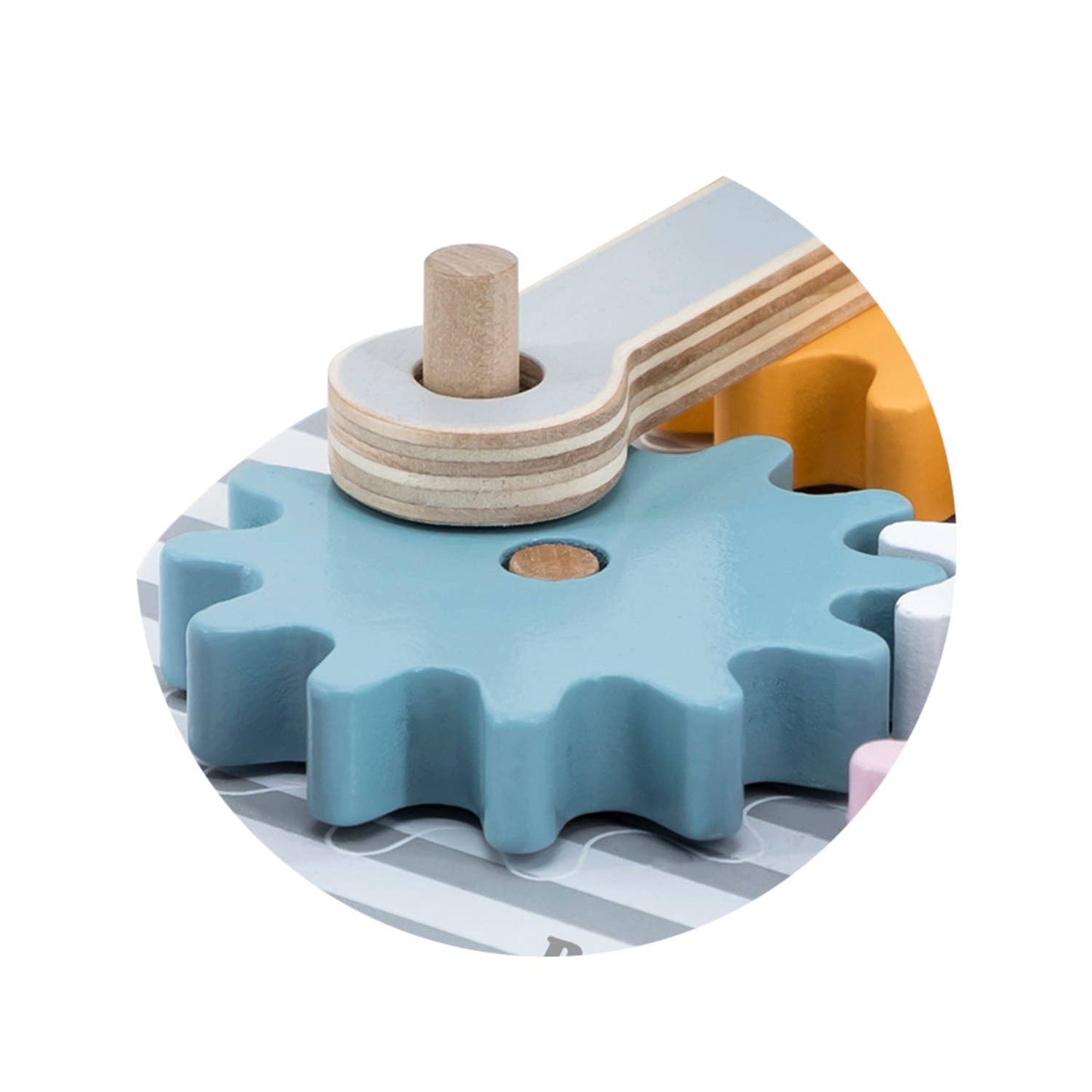 A wooden toy gear puzzle made by PolarB, featuring a circular base with colorful interlocking gears in shades of blue, yellow, pink, and white. The puzzle includes animal figures, such as a blue elephant, pink fox and an orange lion, which can be placed on top of the gears.