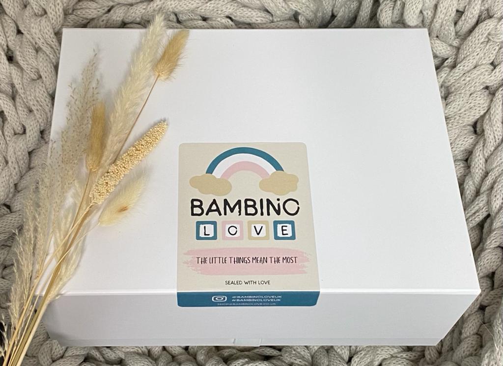 A charming baby hamper from Bambino Love adorned with a bright rainbow, symbolizing happiness and affection.